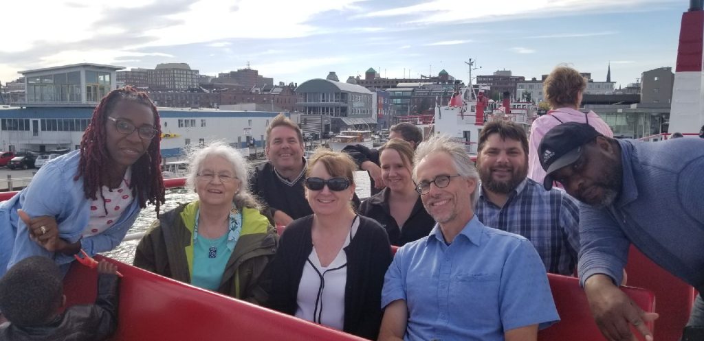 group of adults on a ferry boat